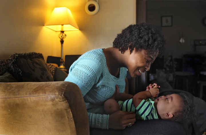 Liasun Hodges of Columbus loves on her son Damani Bonet who was born with Down Syndrome. The local Down Syndrome Association is stepping up outreach efforts to get more black families involved. Just 5 percent of members are African-American, even though blacks are just as likely as whites to have the genetic condition.  (Eric Albrecht / The Columbus Dispatch)